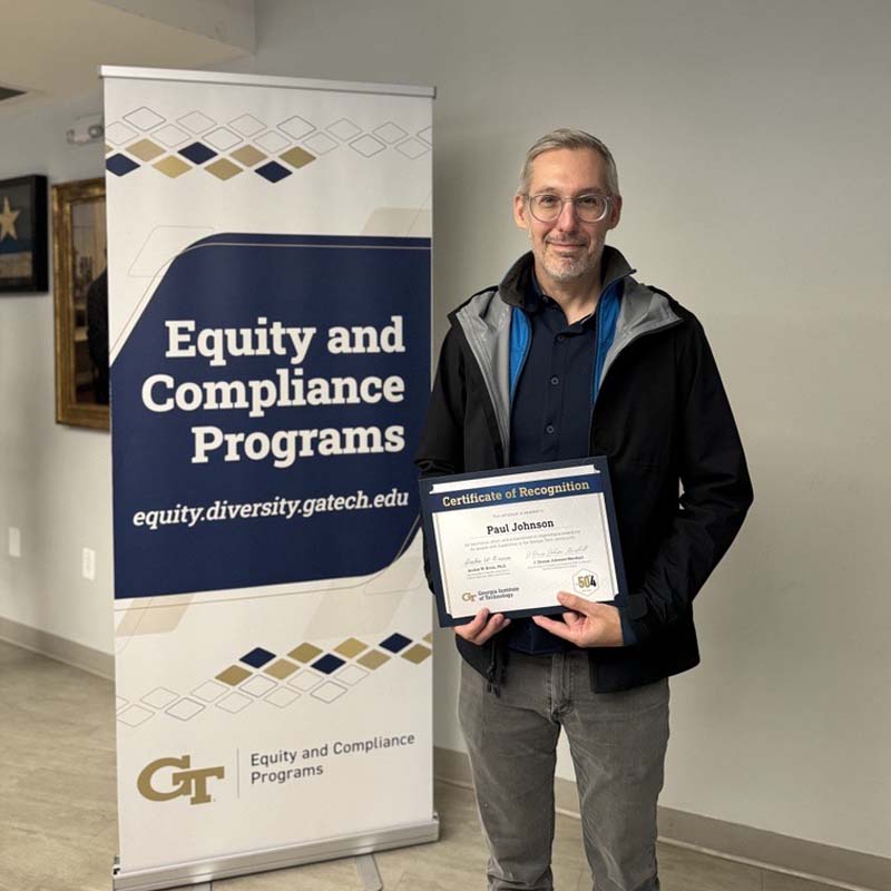 Paul Johnson holds Advocates for Accessibility awards certificate in front of Georgia Tech Equity and Compliance Programs banner. 