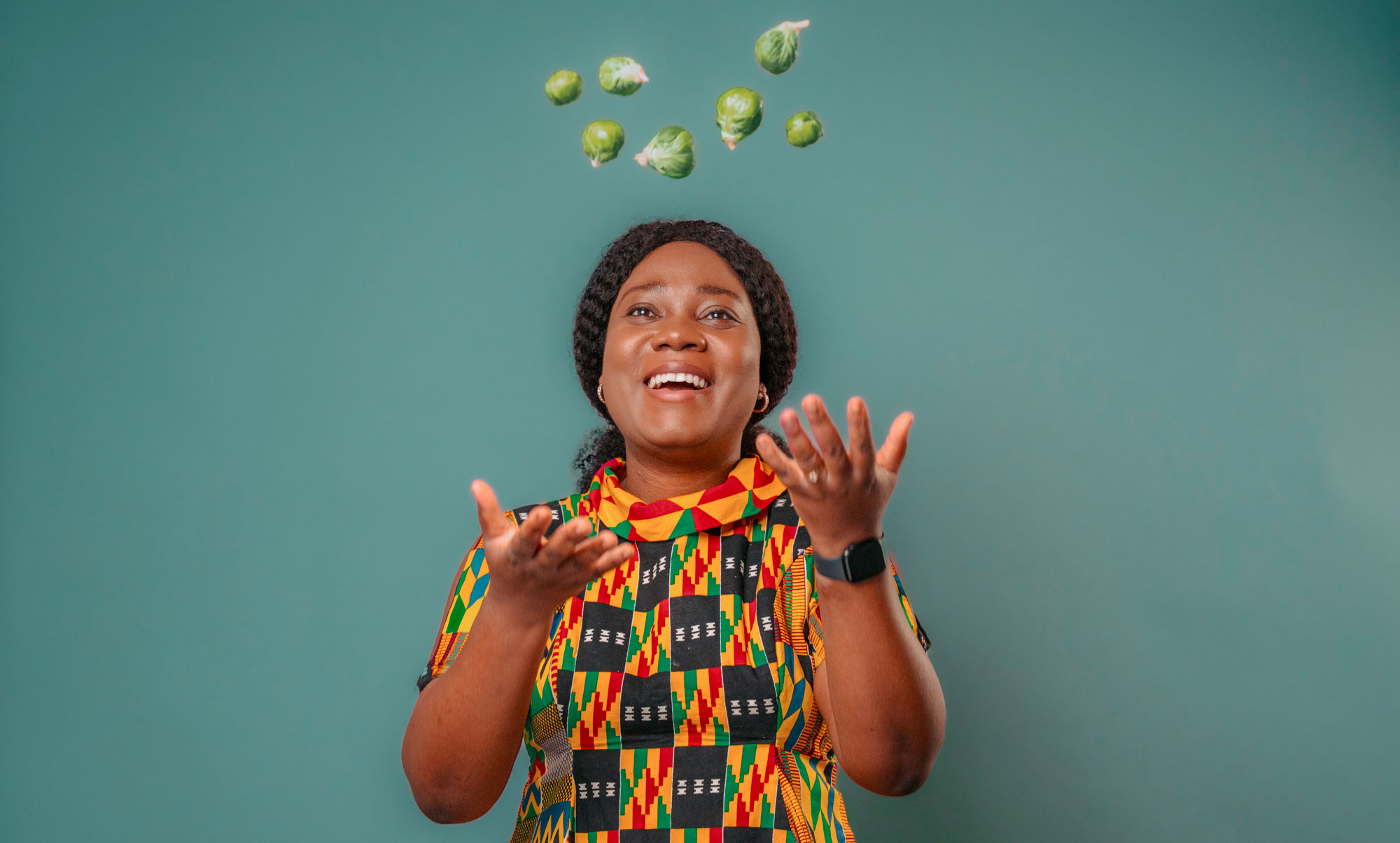Olushola Oladejo throwing brussel sprouts in the air