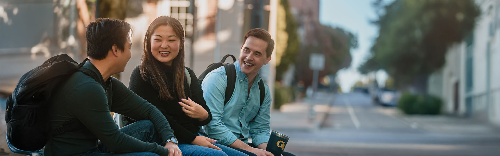 Three Scheller students chatting outside after class