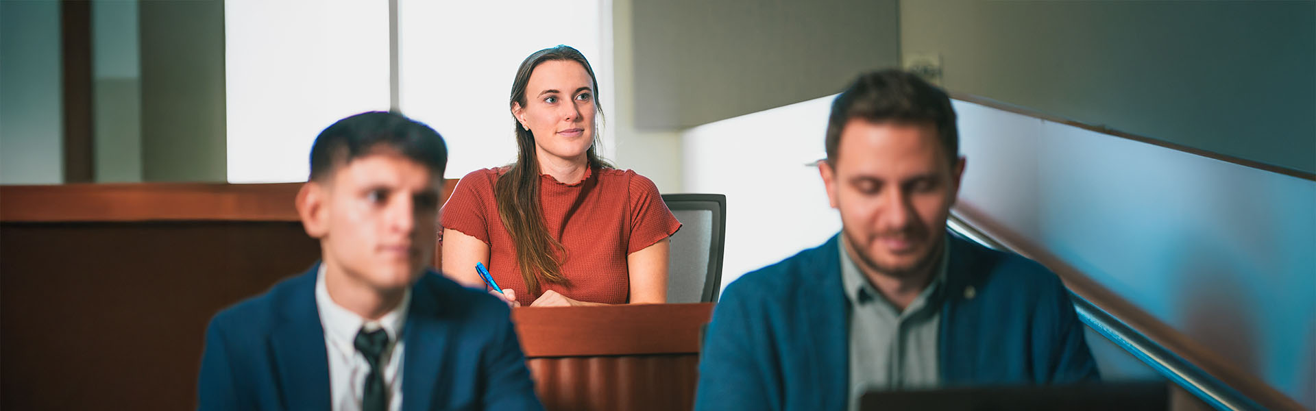 MBA students in classroom facing camera looking at professor