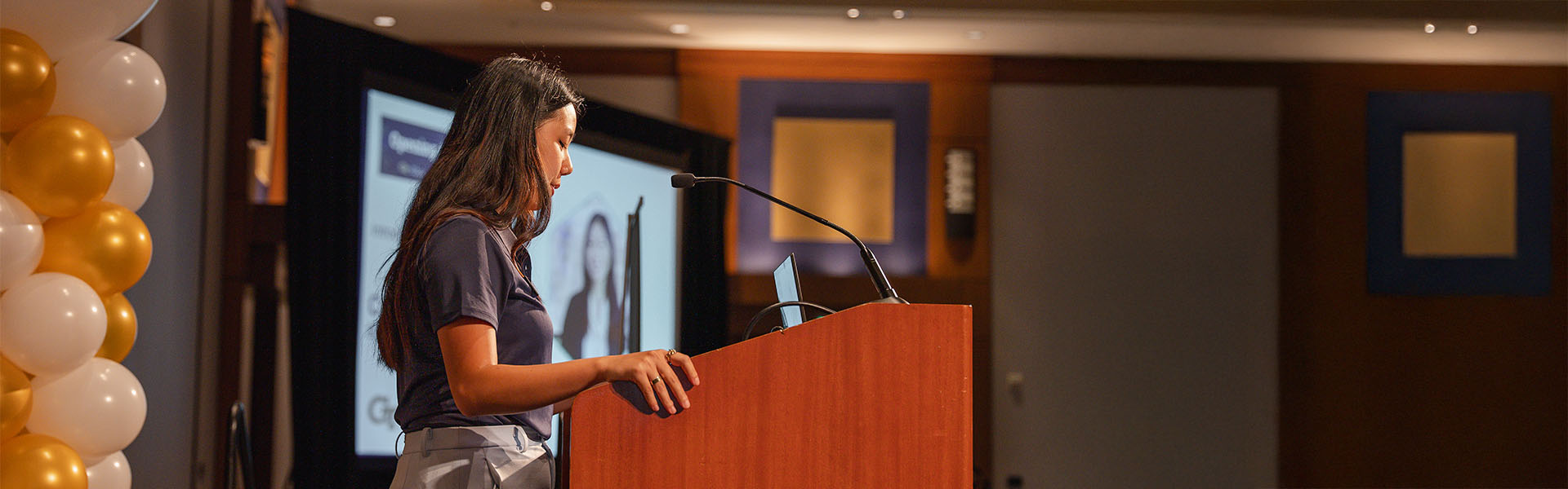 Student giving speech at podium