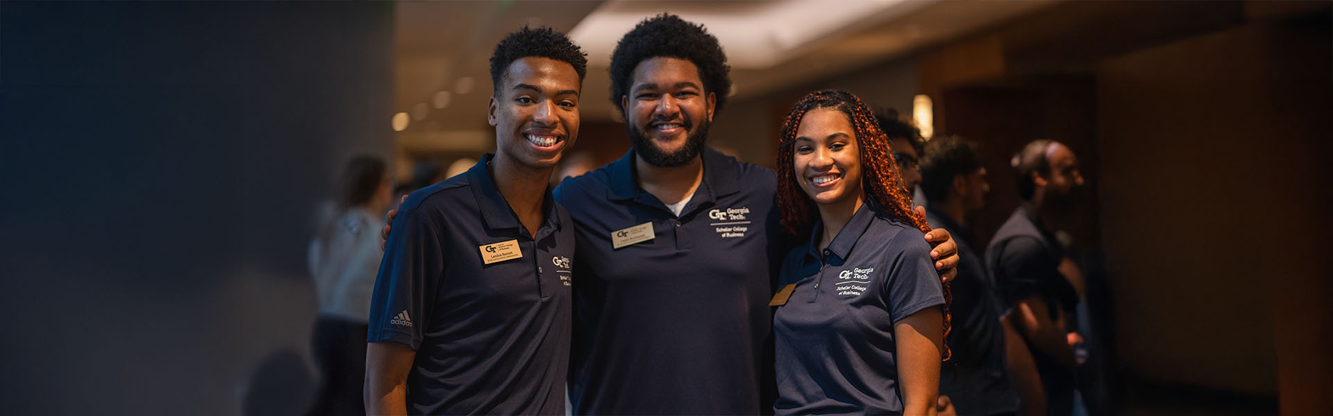 Three undergraduate ambassadors pose for camera during student event