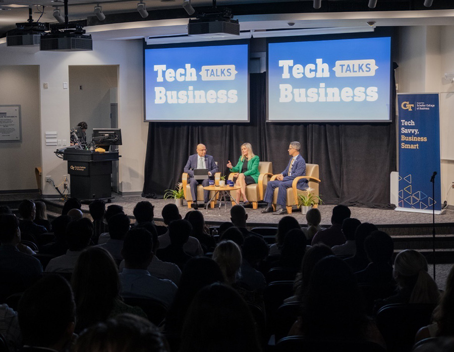 Tech Talks Business panelists Jean Marie Richardson and Daniel Diaz speak with Dean Anuj Mehrotra in front of a crowd of M.S. and MBA students