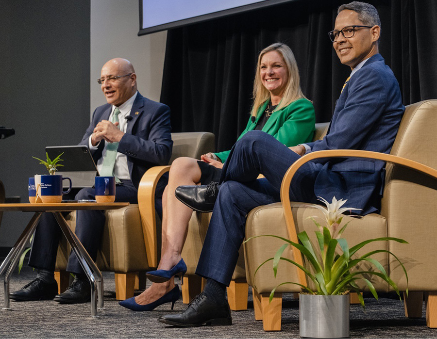 Tech Talks Business panelists Jean Marie Richardson and Daniel Diaz speak with Dean Anuj Mehrotra in front of a crowd of M.S. and MBA students