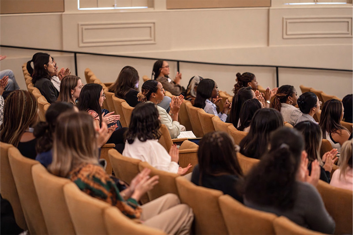 Women in Technology event attendees listen to the keynote speaker, Naomi Davis