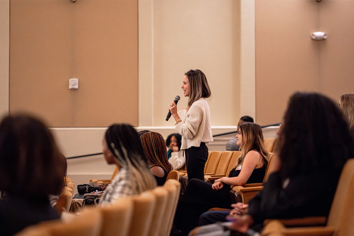 An attendee asks a question during the Q&A portion of the evening