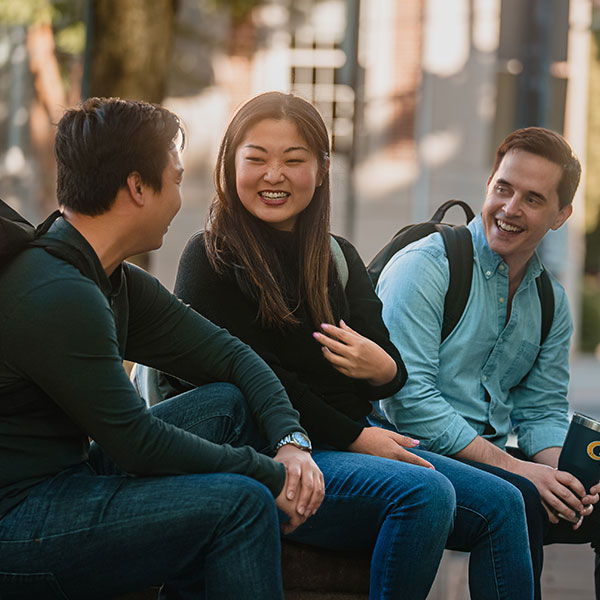 Students smiling in front of Scheller College of Business 