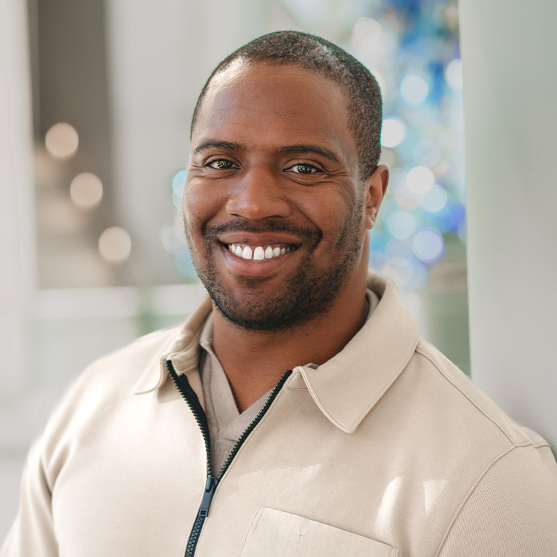 A man with a short beard smiles 