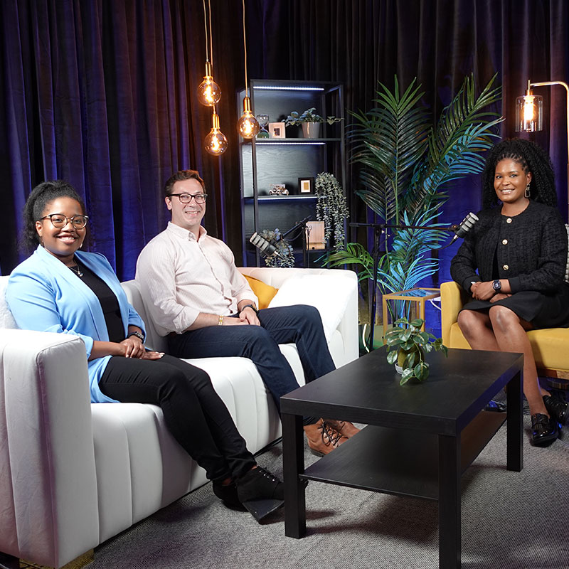 Azell Francis, MBA ‘24, Tony Holubik, MBA ’24, and Analisa Wade, MBA ‘25 sitting down to record a podcast.