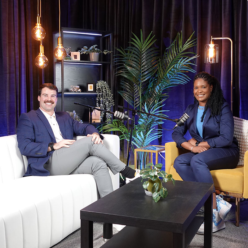 Two MBA students, Trenton Gantt and Analisa Wade, sitting down to record a podcast.