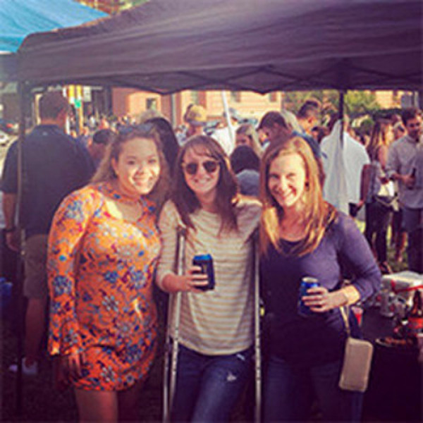 Three women attend a Georgia Tech Homecoming game tailgate event