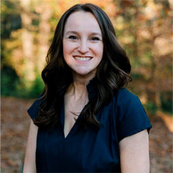 A woman with dark hair smiles