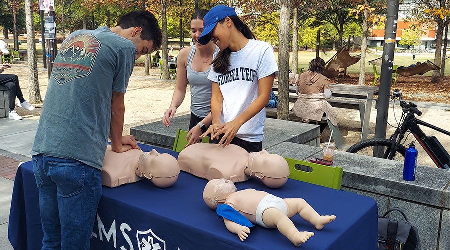 EMT at Tech club members educating passersby on how to perform CPR during EMS at Tech's semesterly CPR-athon.