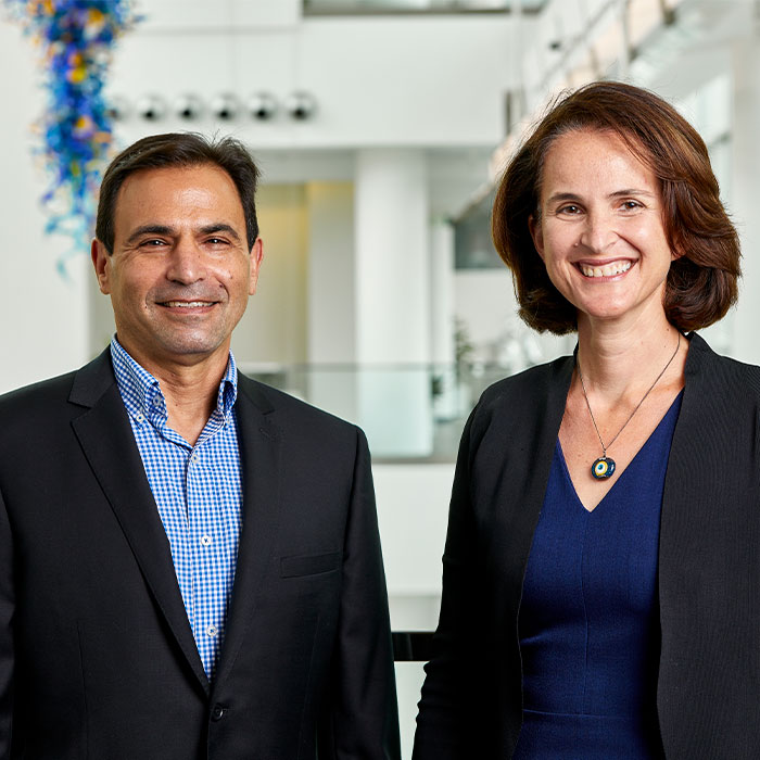 Michael Oxman and Beril Toktay standing side by side in the Scheller College atrium